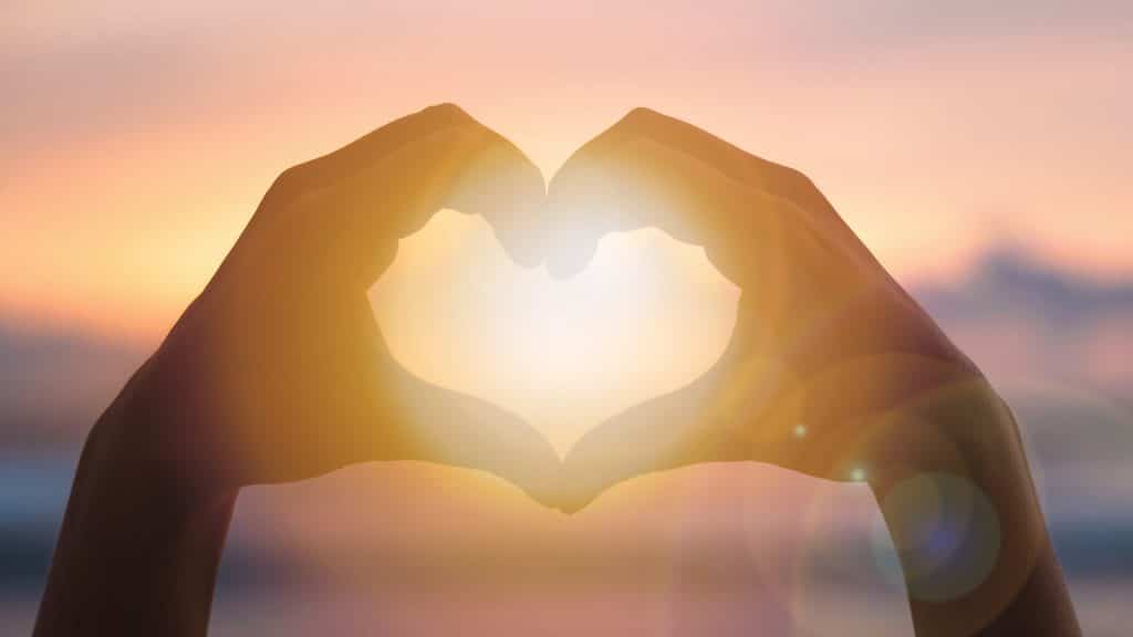 a photo of hands creating a heart.